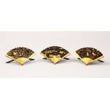 THREE JAPANESE MEIJI PERIOD MIXED METAL MENU HOLDERS, the fan shaped and moulded holders depicting