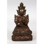 A GOOD EARLY CHINESE BRONZE BUDDHA / DEITY, in a seated position on a lotus base, holding a fruit or