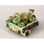 A 20TH CENTURY PERSIAN ISLAMIC PORCELAIN PRODUCE SELLER FIGURE, 7.5cm high x 13cm long