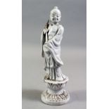 A CHINESE BLANC DE CHINE PORCELAIN FIGURE OF A BOY, standing holding a scepter, on a lotus base,