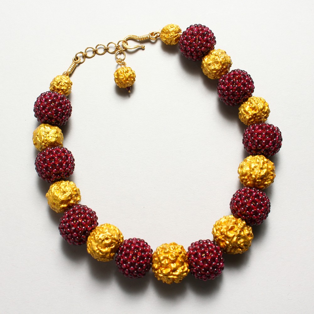 A SET OF NINE SMALL CORAL BEADS AND GILT NECKLACE.
