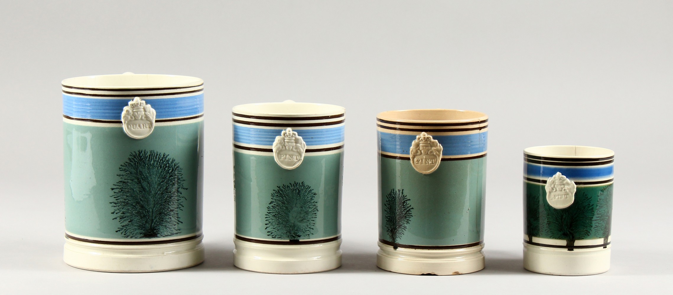 FOUR 19TH CENTURY MOCHA WARE TANKARDS, half pint, 2 x pint and a quart.