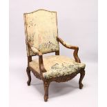 A GOOD 19TH CENTURY CARVED WALNUT FRAMED ARMCHAIR, with tapestry upholstery.