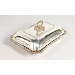 A GOLDSMITH & SILVERSMITH RECTANGULAR ENTREE DISH, COVER AND HANDLE, with gadrooned edge. London