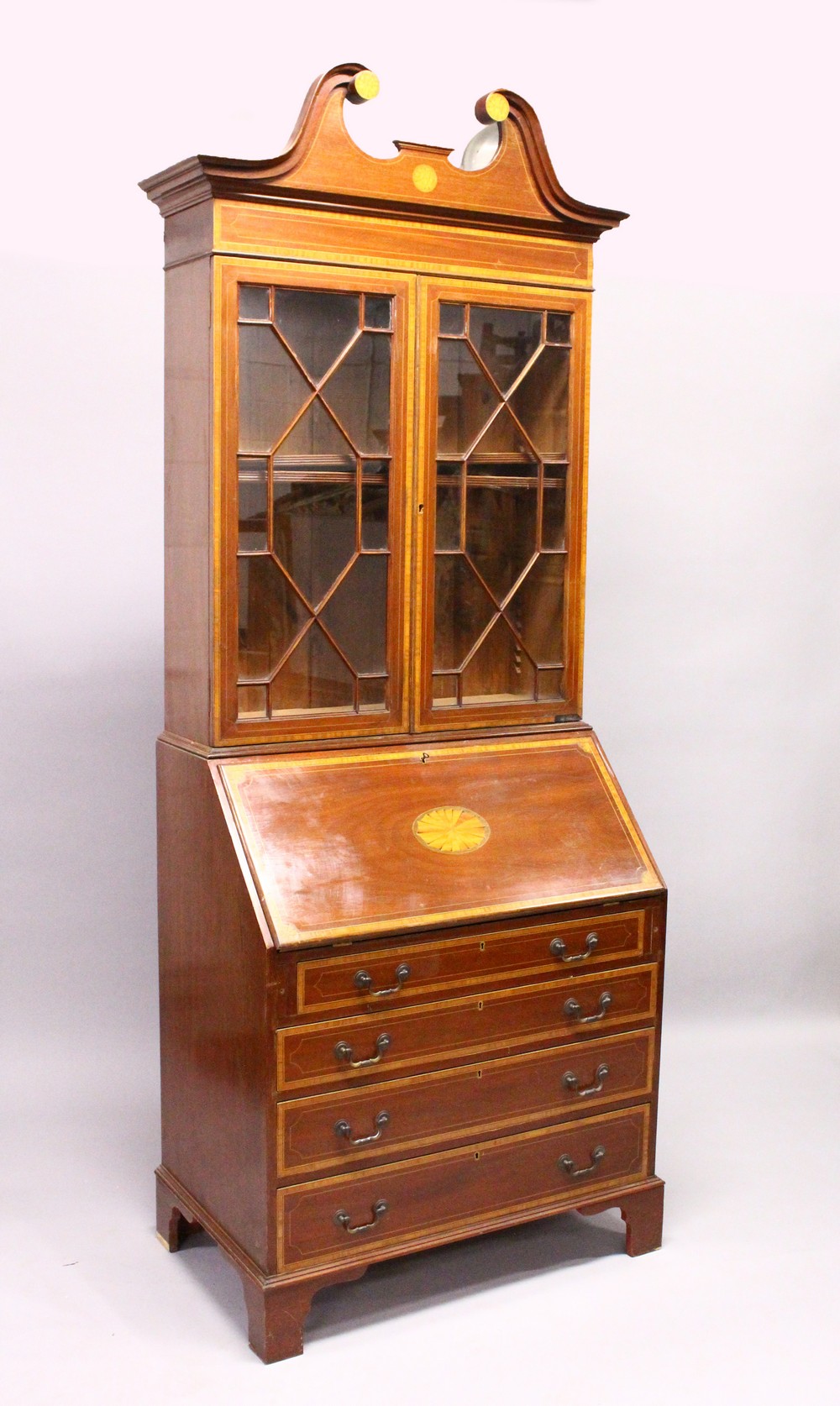 AN EDWARDIAN MAHOGANY AND SATINWOOD INLAID BUREAU BOOKCASE, with swan neck pediment, pair of