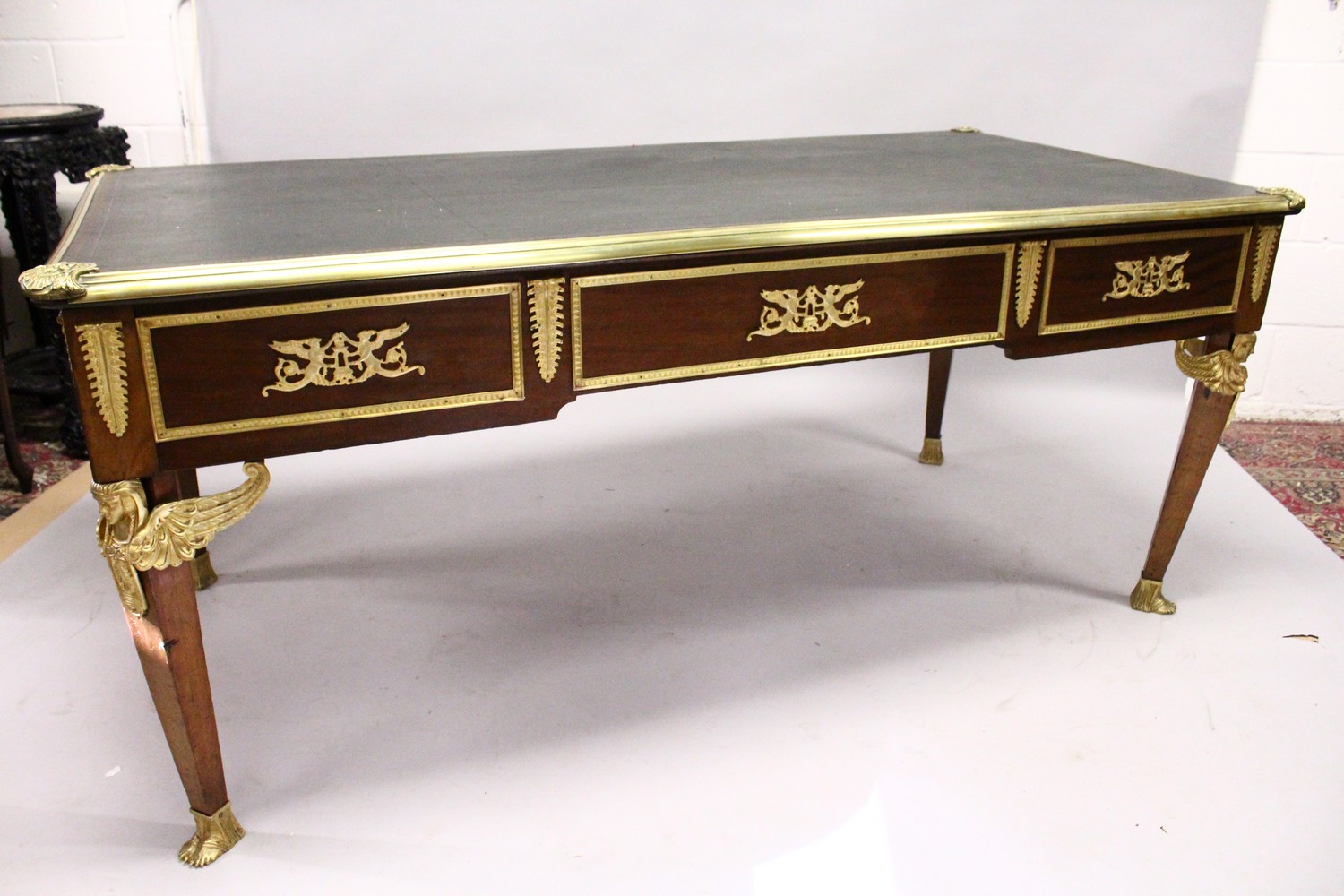 A FRENCH EMPIRE REVIVAL MAHOGANY AND ORMOLU BUREAU PLAT, the leather inset writing surface above a - Image 2 of 6