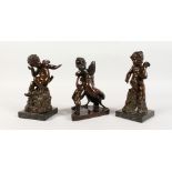 A VERY GOOD PAIR OF BRONZE WINGED CUPIDS, on square marble bases and another wrestling a large