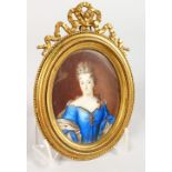 A GOOD 19TH CENTURY OVAL PORTRAIT MINIATURE, of a lady wearing a blue dress, in an ornate ormolu