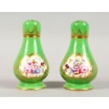 A SMALL PAIR OF APPLE GREEN SCENT BOTTLES AND TOPS, painted with flowers. 4ins high.