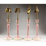 A GOOD SET OF FOUR CONTINENTAL PORCELAIN CIRCULAR TAPERING CANDLESTICKS, painted with roses. 14ins