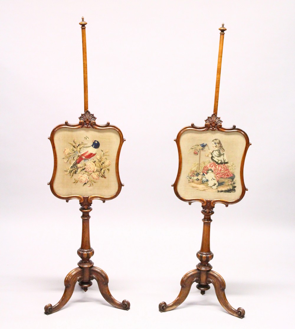 A GOOD PAIR OF VICTORIAN MAHOGANY POLE SCREENS, with Brussels needlework panels of birds, turned