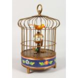 A REPRODUCTION SINGING BIRD CAGE CLOCK. 8ins high.