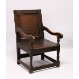 AN 18TH CENTURY OAK WAINSCOT ARMCHAIR, with panelled back, solid seat on bobbin turned front legs.