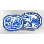 TWO WILLOW PATTERN BLUE AND WHITE SERVING DISHES (one AF). 19.5ins and 20.5ins .