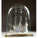 A FINE GLASS MODEL OF A GALLEON; together with a smaller ship and lighthouse, under a glass dome.