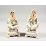 A PAIR OF 19TH CENTURY PORCELAIN INCENSE HOLDERS, modelled as seated male and female Turkish