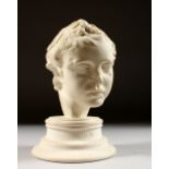 A 20TH CENTURY PARIAN WARE BUST OF EROS. 7ins high.
