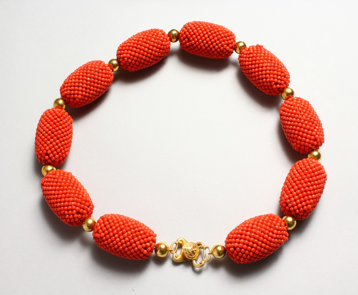 A SET OF NINE LARGE CORAL BEADS NECKLACE.