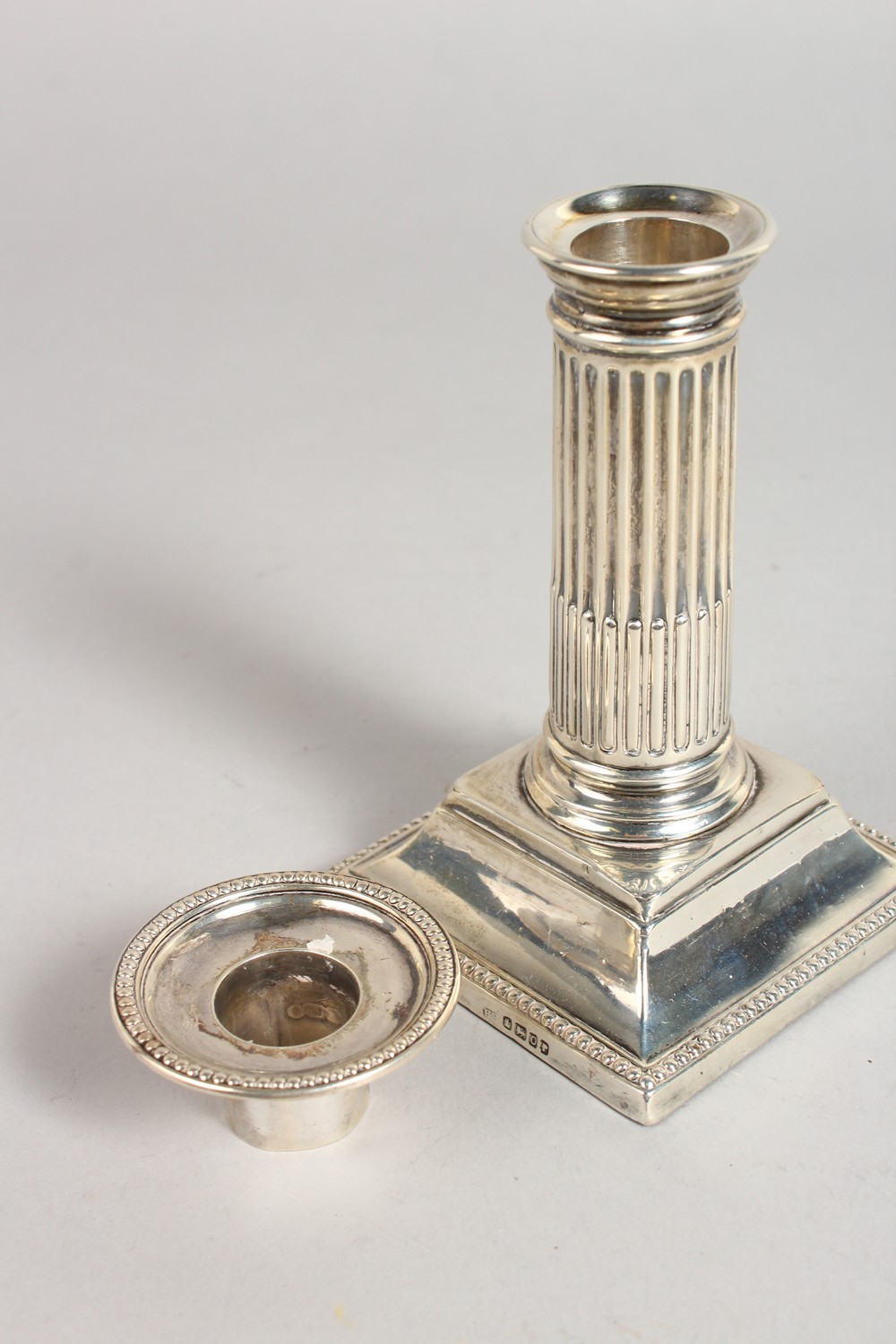A VICTORIAN CANDLESTICK, with fluted columns, on a square base. 5ins high. Sheffield 1881. Maker: - Image 2 of 5