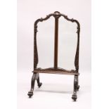 A GOOD 19TH CENTURY CARVED MAHOGANY FOLDING SCREEN, with three glazed panels on four curving legs,