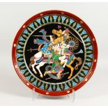 A SUPERB LARGE PORCELAIN CIRCULAR CHARGER, with a Russian scene of warriors on horseback. 18.5ins