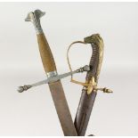 A CAVALRY SWORD, plain curved blade, brass stirrup hilt with horses head pommel, brass scabbard