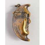 A NOVELTY BRASS HALF MOON VESTA.