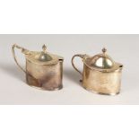A PAIR OF OVAL MUSTARD POTS AND COVERS, with sapphire blue liners. Chester 1909.