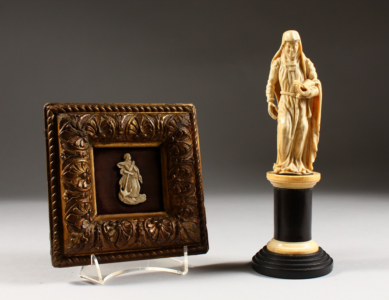 A 19TH CENTURY IVORY FIGURE ON STAND, possibly St Anne; together with a small ivory in a gilt frame.