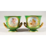 A GOOD PAIR OF SEVRES APPLE GREEN TWO-HANDLED URNS, with gilt decoration and painted with reverse