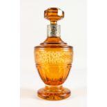 A BOHEMIAN AMBER ENGRAVED SCENT BOTTLE AND STOPPER, with silver band. 10ins high.