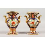 A PAIR OF SPODE JAPAN PATTERN URN SHAPED VASES, with mask handles. 5ins high.