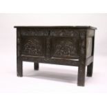 AN 18TH CENTURY OAK COFFER, with two panels to the rising top, and front with carved frieze and