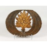 A CARVED AND PARCEL GILDED PLAQUE DEPICTING A WHEATSHEAF. 18ins wide.