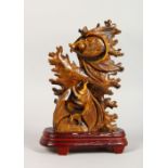 A CHINESE CARVED TIGER'S EYE FISH GROUP on a stand. 8ins high.
