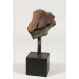 A SMALL PIECE OF METEORITE, on stand. 8ins high.