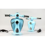 A SMALL PAIR OF LIGHT BLUE VESPA LAMPS.