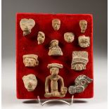 A COLLECTION OF TERRACOTTA SOUTH AMERICAN ANTIQUITY FRAGMENTS, mounted on a board. 8.5ins high.