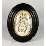 A RELIEF MOULDED PLASTER PLAQUE DEPICTING THE NATIVITY, in an ebonised oval frame. 17ins x 14ins.