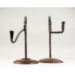 TWO 18TH/19TH CENTURY WROUGHT IRON COMBINATION CANDLESTICKS/RUSH LIGHT HOLDERS, on circular bases.