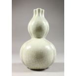 A CHINESE CRACKLE GLAZE TRIPLE NECK VASE. 10ins high.