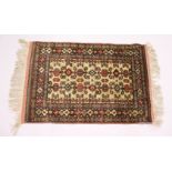 A NORTH EAST PERSIAN SARKHAS SILK RUG, beige ground with Caucasian Perdidil design.