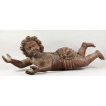 A LARGE CARVED WOOD PUTTI. 3ft 9ins long.