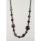 A BANDED AGATE NECKLACE. 18ins long.