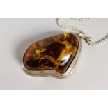 A LARGE PENDANT on a chain. Butterfly in simulation amber.
