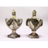 A PAIR OF CARVED MARBLE URN SHAPED GATEPOST FINIALS. 18ins high.