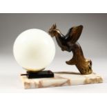 AN ART DECO LAMP, modelled as a cockerel by a sphere, on a marble base. 10ins long.