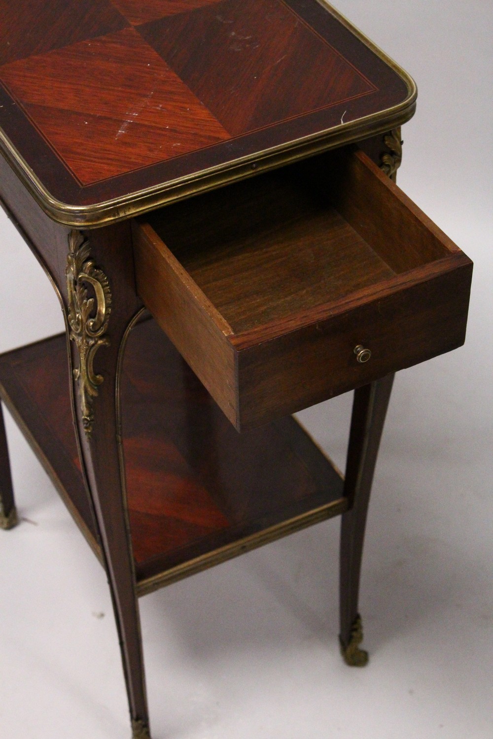 A SMALL LATE 19TH CENTURY FRENCH MAHOGANY AND ORMOLU TABLE, with a drawer to one end, on slender - Image 3 of 3