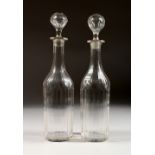 A PAIR OF 19TH CENTURY CUT GLASS DECANTERS AND STOPPERS. 13ins high.
