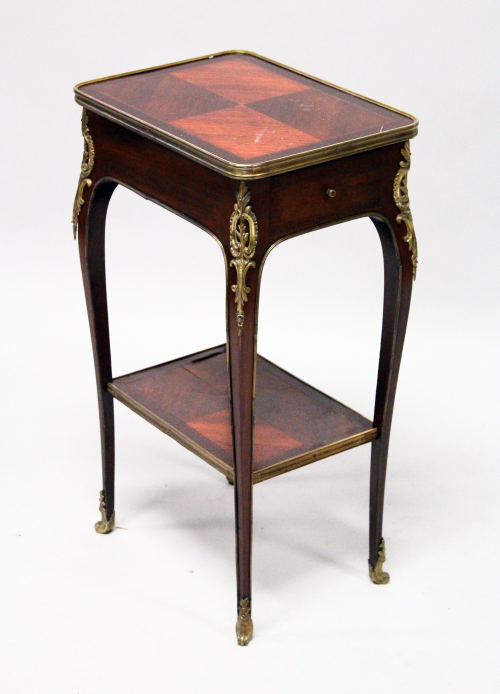 A SMALL LATE 19TH CENTURY FRENCH MAHOGANY AND ORMOLU TABLE, with a drawer to one end, on slender